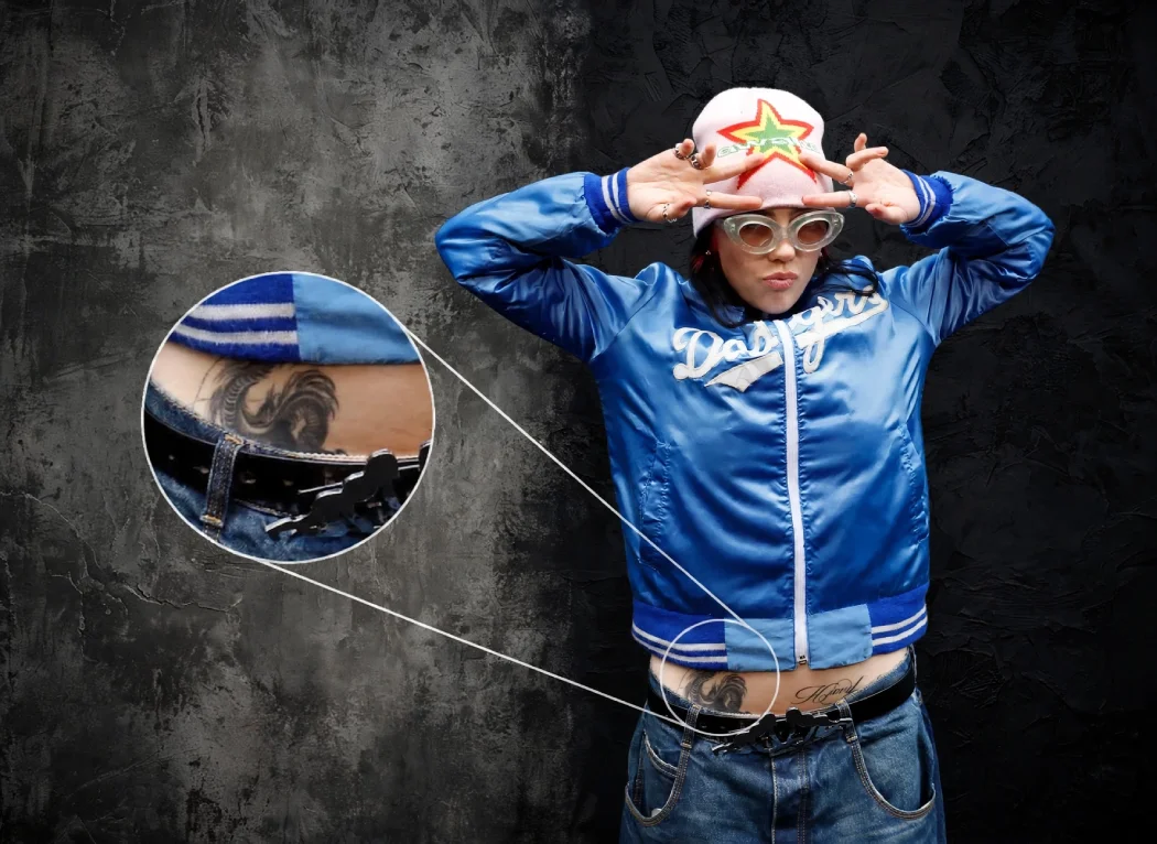 Billie Eilish showing lower stomach dragon tattoo with zoomed inset detail in blue Dodgers jacket